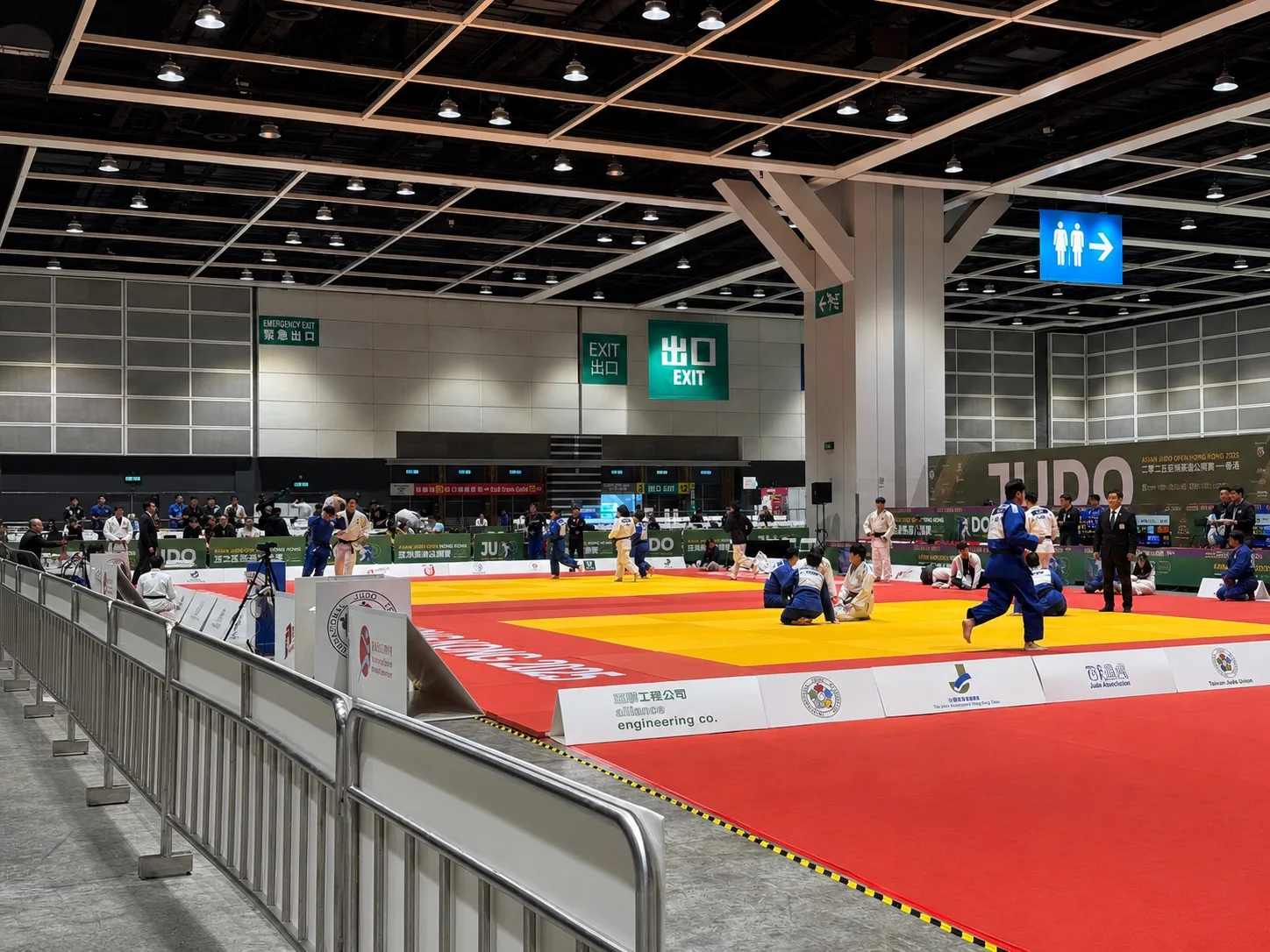 A Hong Kong judo competition venue with several tatami areas in use