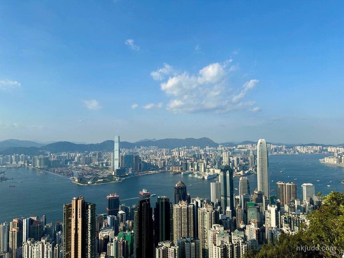 Editorial image of Hong Kong's Victoria Harbour seen from above, with Hong Kong Island in the foreground and Kowloon across the water