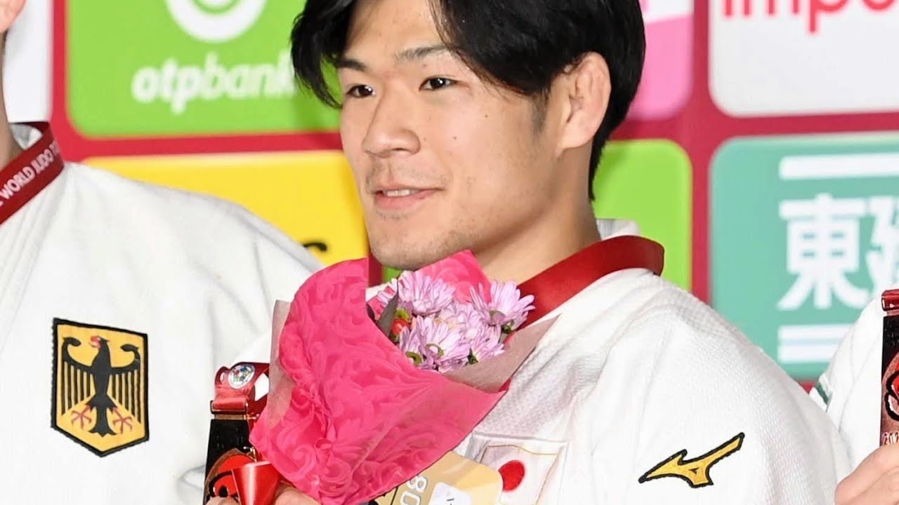 Kosuke Mashiyama in judo gi with Japan and Mongolia flags (YouTube still, Tokyo News (YouTube))