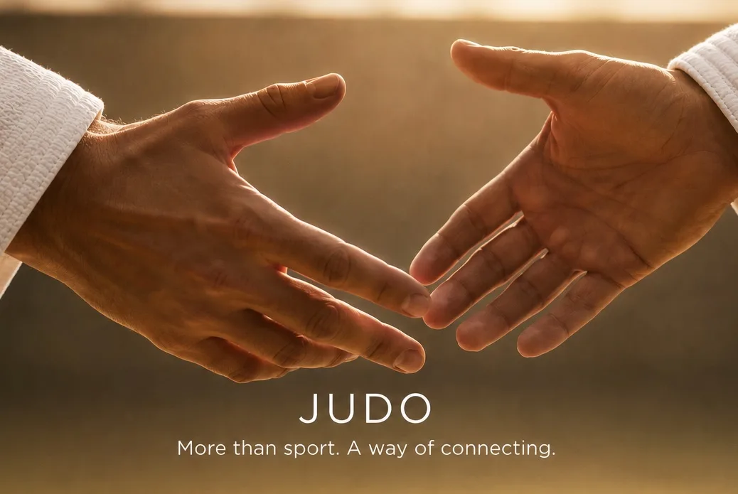 Two judoka reach toward each other by hand, illustrating trust and connection in para judo.